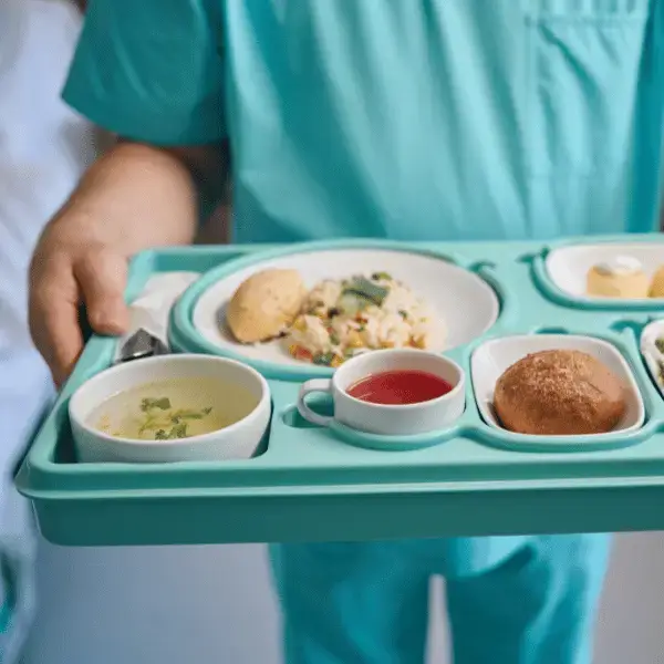 Hospital staff serving a nutritious meal on a tray at the Dietary Department of Nazarenus Hospital Bulacan